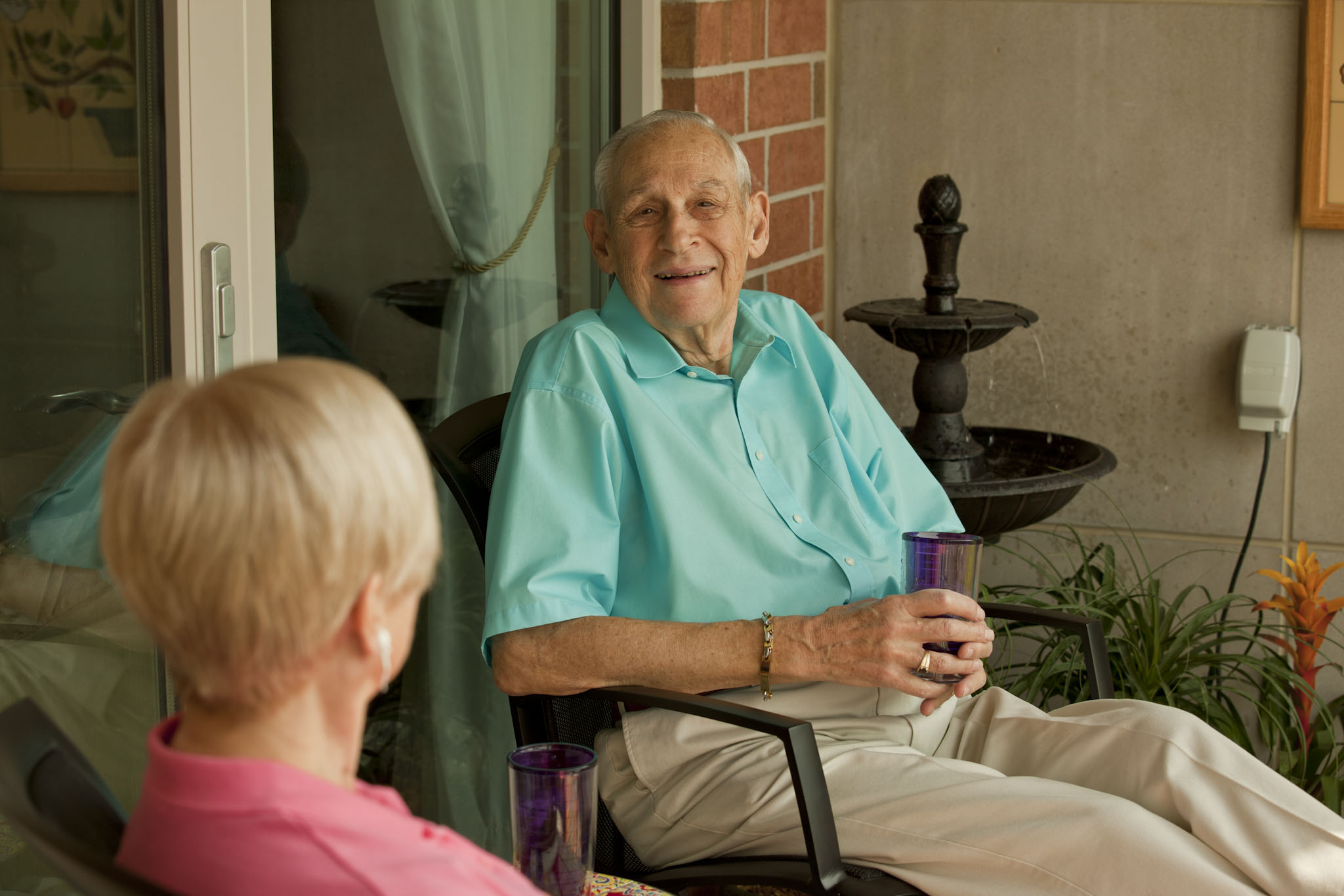 Senior couple sitting on patio talking