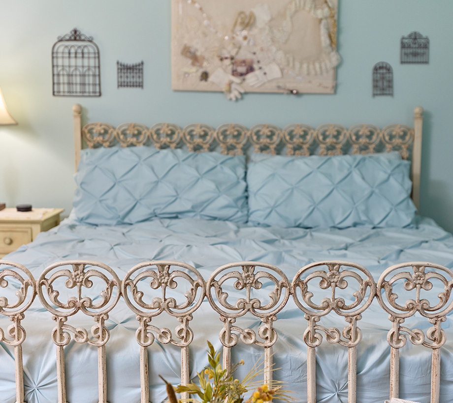 Close up shot of senior living bedroom with blue bedding and decor.