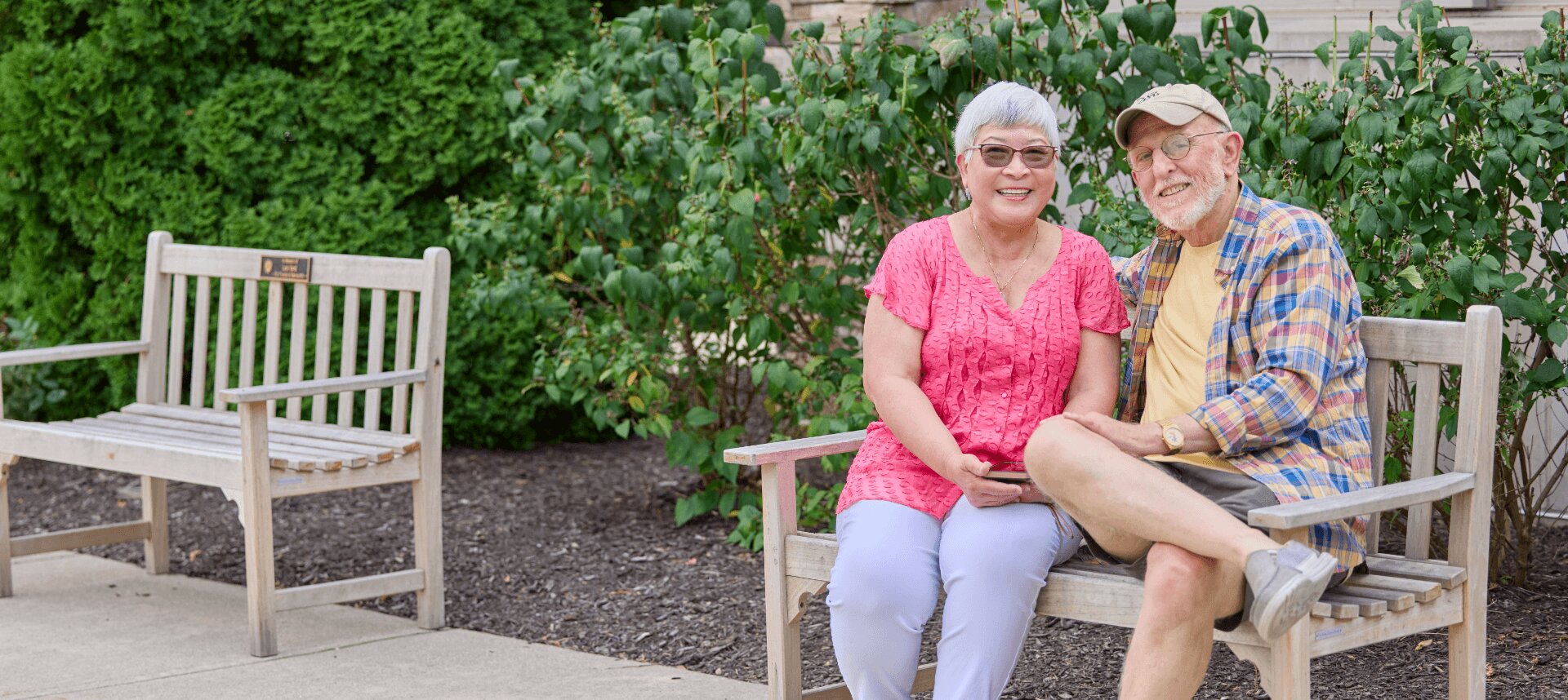 senior couple sitting on outdoor bench