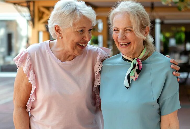 Senior women walking arm in arm