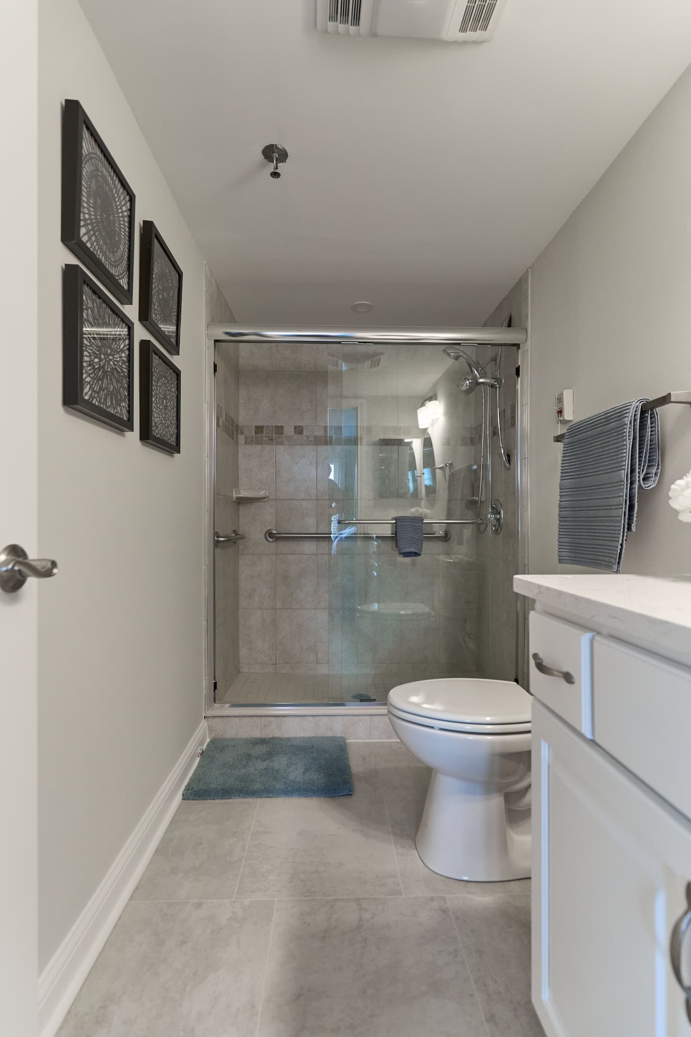 Modern bathroom in a unit with tiled shower and stylish fixtures.